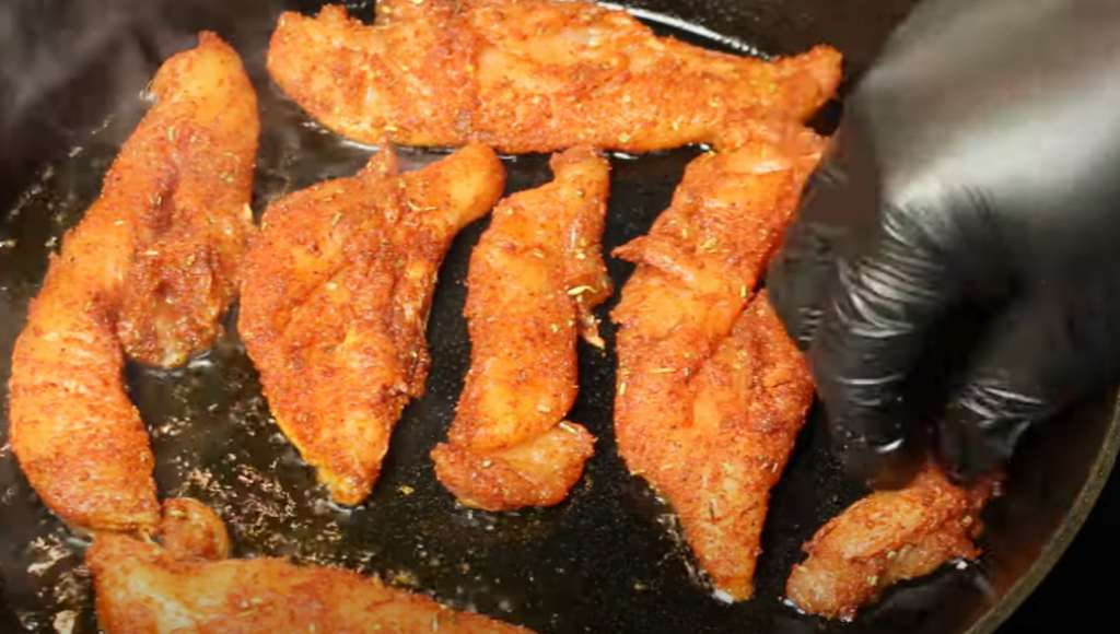 Heat oil in pan and put chicken tenders